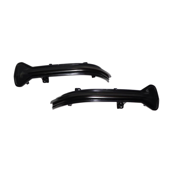 Two curved black plastic car parts lay side by side on a white background, each featuring a broad base and a tapered end, likely designed for mounting on a vehicle.