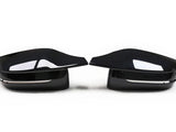 Two glossy black car side mirrors facing each other, set against a plain white background. They have a sleek, aerodynamic design with a subtle chrome accent beneath.