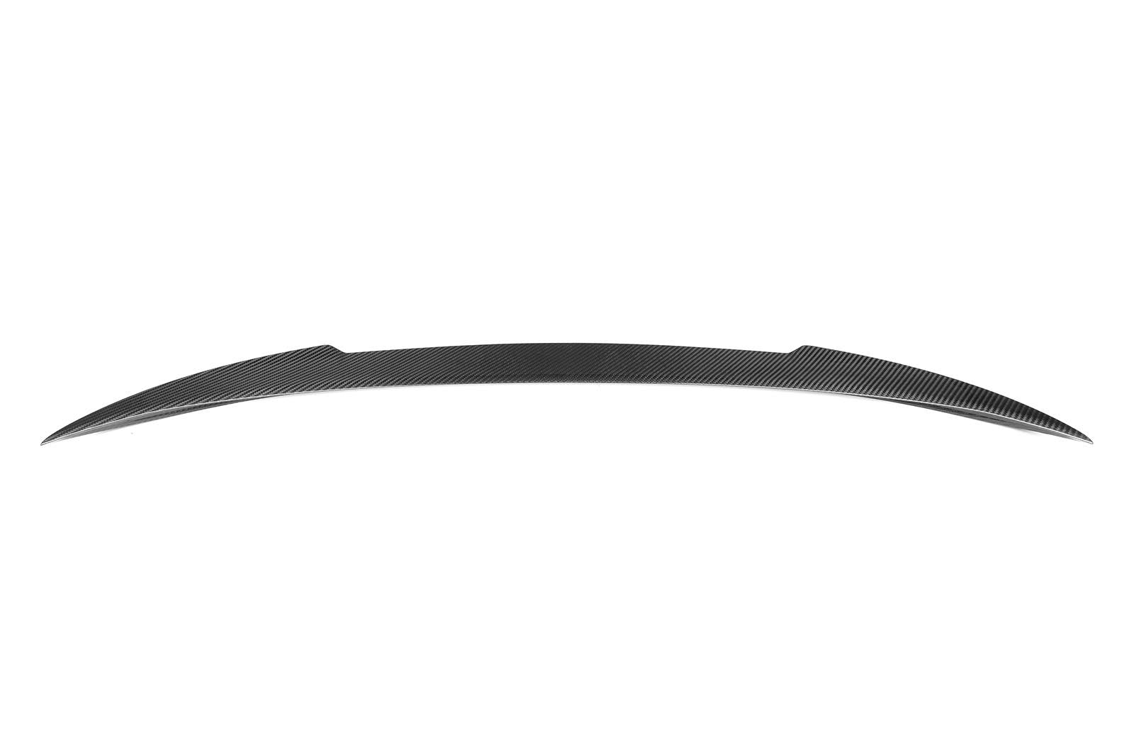 A sleek, curved carbon fiber spoiler rests against a plain white background, showcasing its streamlined design and subtle patterning ideal for automotive aerodynamic enhancement.