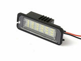 Rectangular LED light with multiple yellow diodes, installed in a black housing. It features a textured lens cover and is connected to red and black wires, set against a plain white background.