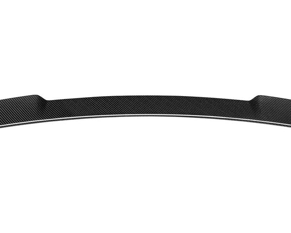 A curved carbon fiber car spoiler, positioned horizontally with tapered ends, displayed against a plain white background.