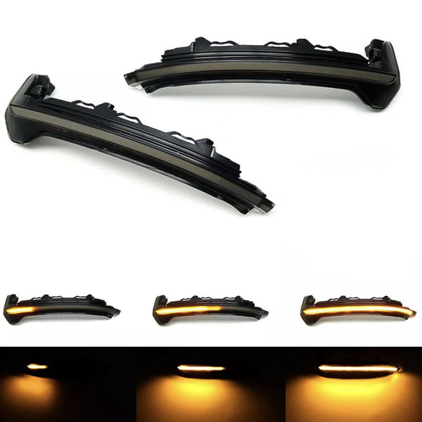 Two black LED car indicator lights, one above the other, illuminate sequentially in orange, showcased against a white and dark background to highlight varying light intensities.