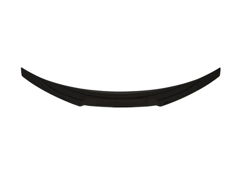 A curved, black car spoiler lies horizontally against a plain white background.