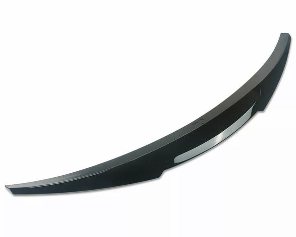 A curved black car bumper spoiler sits isolated against a plain white background, designed to enhance vehicle aerodynamics.