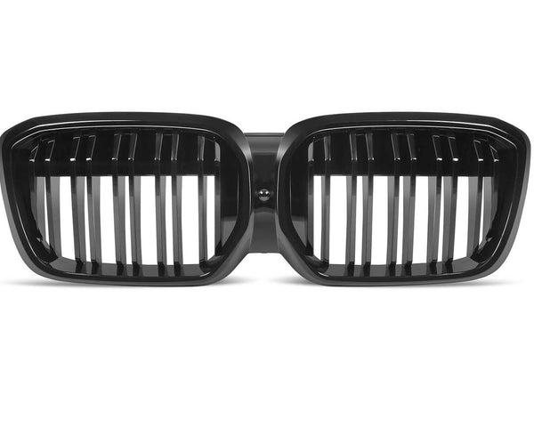 A dual kidney-shaped, black car grille with vertical slats is displayed against a plain white background.