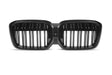 A dual kidney-shaped, black car grille with vertical slats is displayed against a plain white background.