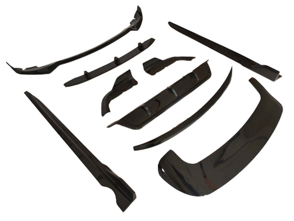 Black automobile body kit components are arranged on a white background. The kit includes various aerodynamic pieces like a front lip and side skirts, designed for vehicle exterior enhancements.