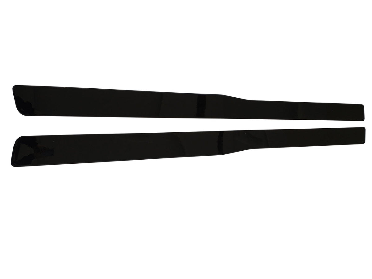 Two black, rectangular helicopter rotor blades lie parallel on a white background, showcasing their sleek, streamlined design and glossy surface.