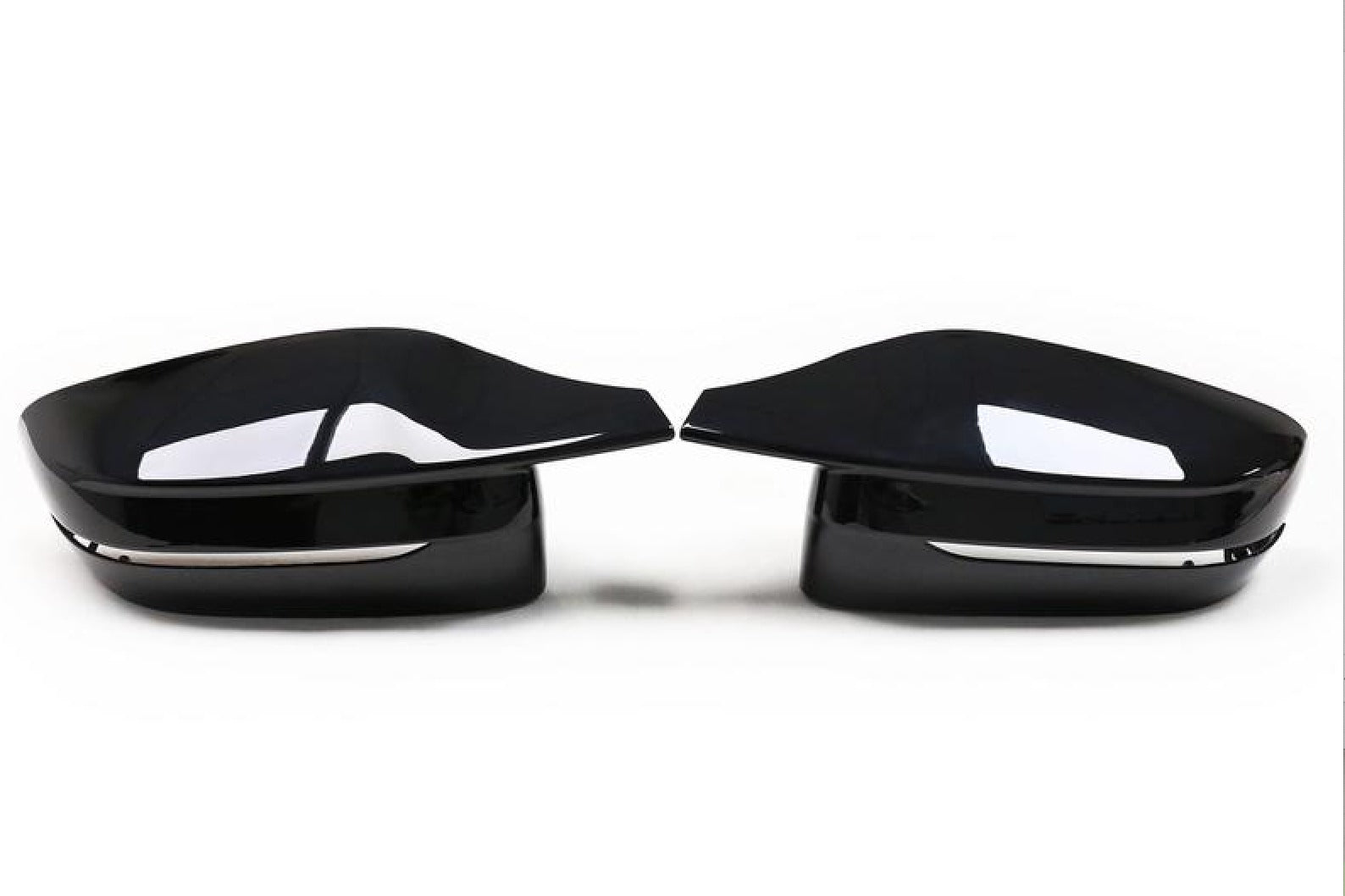 Two sleek, black car side mirrors face each other, reflecting light. They are placed on a plain white background, emphasizing their glossy surface and modern design.