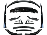 Various black car body kit components, including spoilers and diffusers, arranged symmetrically on a white background, showcasing their design and shape for automotive customization.