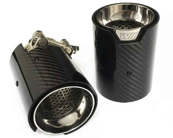 Two cylindrical, carbon fiber car exhaust tips, one upright with "WII" text, the other lying down, featuring stainless steel interior, perforations, and clamp mechanism; set against a white background.