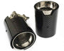 Two cylindrical, carbon fiber car exhaust tips, one upright with "WII" text, the other lying down, featuring stainless steel interior, perforations, and clamp mechanism; set against a white background.