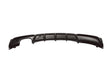 A black automotive rear diffuser with aerodynamic fins, resting against a plain white background, showcasing its sleek design for enhancing vehicle stability.