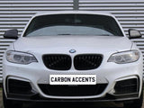 A white BMW car is parked with a focus on its front grille and headlights. The background features corrugated metal. The license plate displays the text 