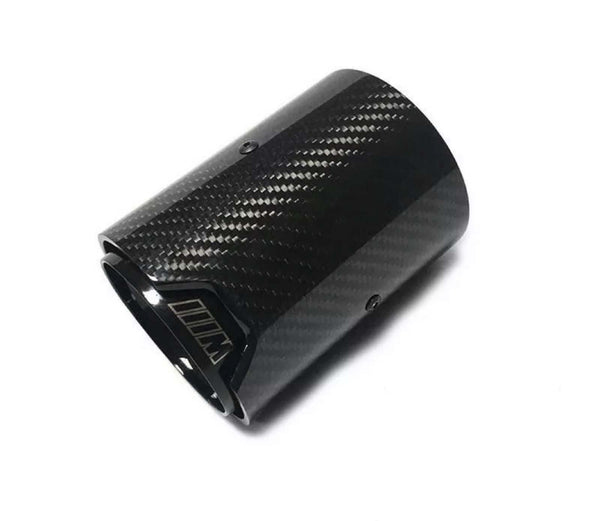 A carbon fiber exhaust tip lies angled on a white background, featuring a glossy checkered pattern with the letter "M" visible near the opening.