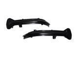 Two black, curved plastic car parts with attachment points rest against a white background, likely designed for vehicle installation or modification.