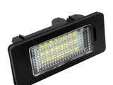A rectangular LED light with a black frame and grid-patterned lens is positioned at an angle. It is designed for automotive use, providing illumination in vehicle settings.
