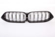 A black car grille with parallel vertical slats, forming a dual-kidney shape, is centered on a plain white background.