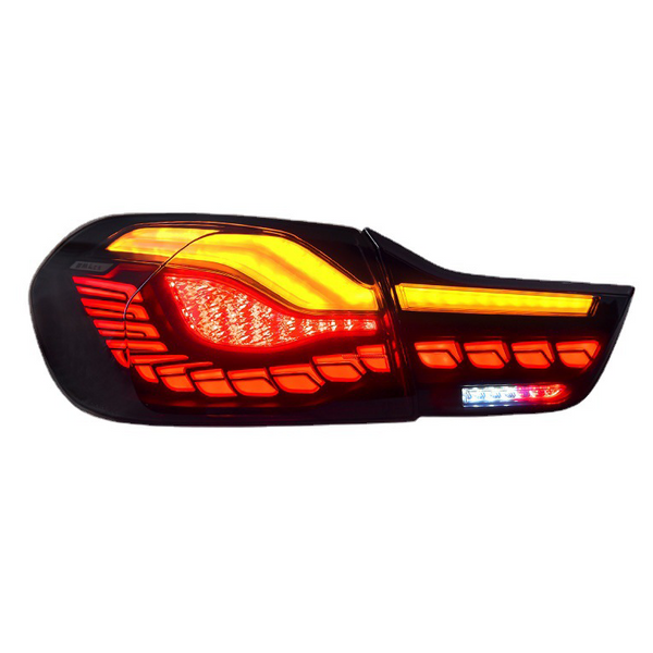 A car tail light emits bright red and amber lights, featuring modern, segmented design elements against a white background.