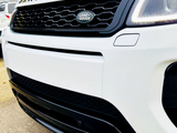 A white Range Rover front grille displays the 