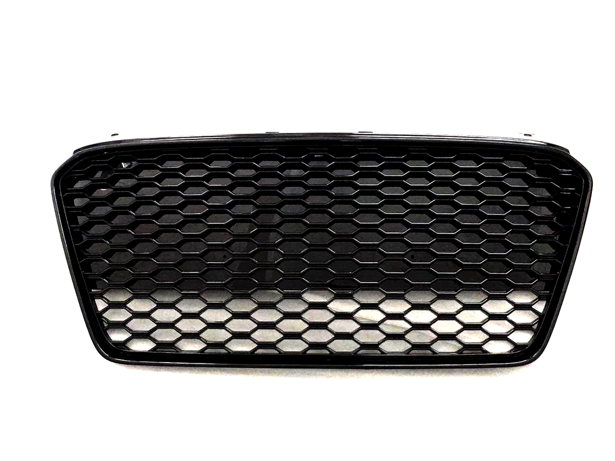 A black car grille with a honeycomb pattern appears against a plain white background, showcasing its sleek design and geometric texture.