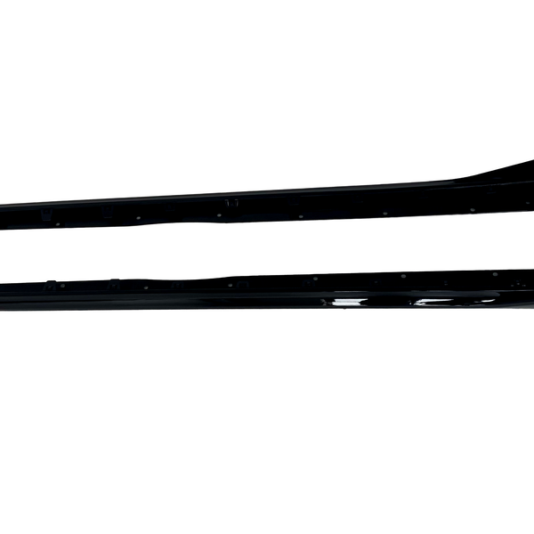 Two long, black vehicle side skirts are positioned horizontally on a white background, each displaying a sleek, aerodynamic design with smooth, glossy surfaces.