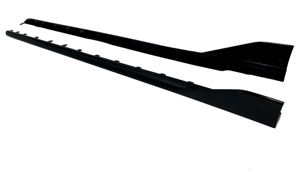 Two long, black car side skirts are positioned parallel on a white background, showcasing attachment points and a sleek, aerodynamic shape.