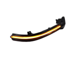 Curved LED car light blinks amber, set in a black casing, isolated on a plain white background.