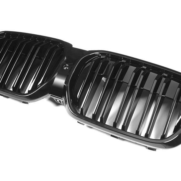 Black twin kidney-shaped car grille featuring vertical bars, resting on a plain white background.
