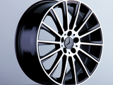 A sleek, black alloy wheel with a silver rim and star emblem rests on a pedestal against a plain grey background.