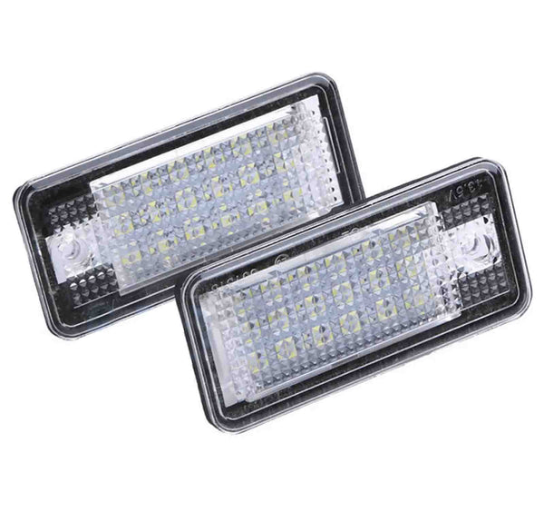 Two rectangular LED light fixtures arranged diagonally overlap slightly, set against a white background. The lights feature a grid-like pattern of small bulbs within a clear casing.