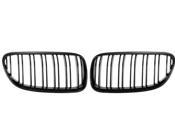 Two black kidney-shaped car grilles with vertical slats are positioned side by side against a plain white background.