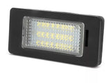 A rectangular LED light with a black frame, the LEDs illuminate through a textured lens. Set against a plain white background. Text on lens: “315, 101363.”