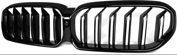 A glossy black dual-section car grille with vertical slats, central mounting point, and curved edges; displayed against a plain white background.