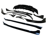 Black car body kit components are arranged neatly on a white background, including a front splitter, side skirts, and fender flares, displaying their glossy finish and aerodynamic design.