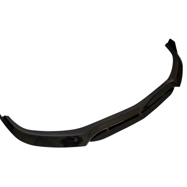 A glossy black car splitter viewed against a plain white background, showcasing its aerodynamic shape with a slightly curved design and mounting brackets.