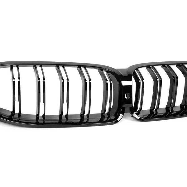 A black car front grille with vertical slats, featuring a kidney-shaped design. It rests on a plain white background, highlighting its glossy finish and sleek appearance.