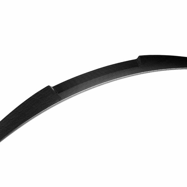 Curved, black carbon fiber spoiler resting against a white background, showing a sleek, aerodynamic design with textured surface detail.