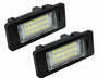 Two rectangular LED car lights, featuring multiple yellow LEDs, are positioned at an angle, surrounded by a black casing, on a plain white background.
