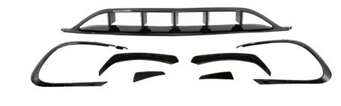 Car body kit components are arranged on a white background, including bumper covers and aerodynamic trim pieces, all in shiny black, designed to enhance vehicle appearance and performance.