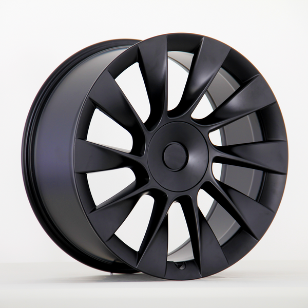 Black alloy wheel with a sleek, multi-spoke design is upright against a plain white background, highlighting its modern and aerodynamic appearance.
