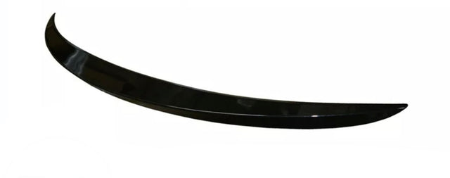A sleek, black, curved car spoiler rests against a plain white background, showcasing its aerodynamic design and glossy finish.