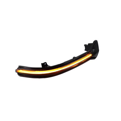 A curved LED car taillight glows brightly with an amber strip, positioned against a plain white background.