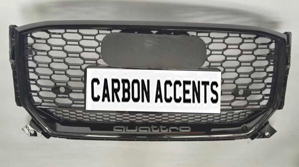 Grille with honeycomb pattern displayed on a light background. It features text "CARBON ACCENTS" on a license plate, with "quattro" written below in smaller lettering.