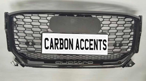 Grille with honeycomb pattern displayed on a light background. It features text "CARBON ACCENTS" on a license plate, with "quattro" written below in smaller lettering.