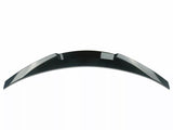 A shiny, black car spoiler curves upward against a plain white background, designed for aerodynamic enhancement and style.