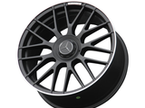 A black alloy car wheel with a multi-spoke design features a central emblem, the Mercedes-Benz logo. 