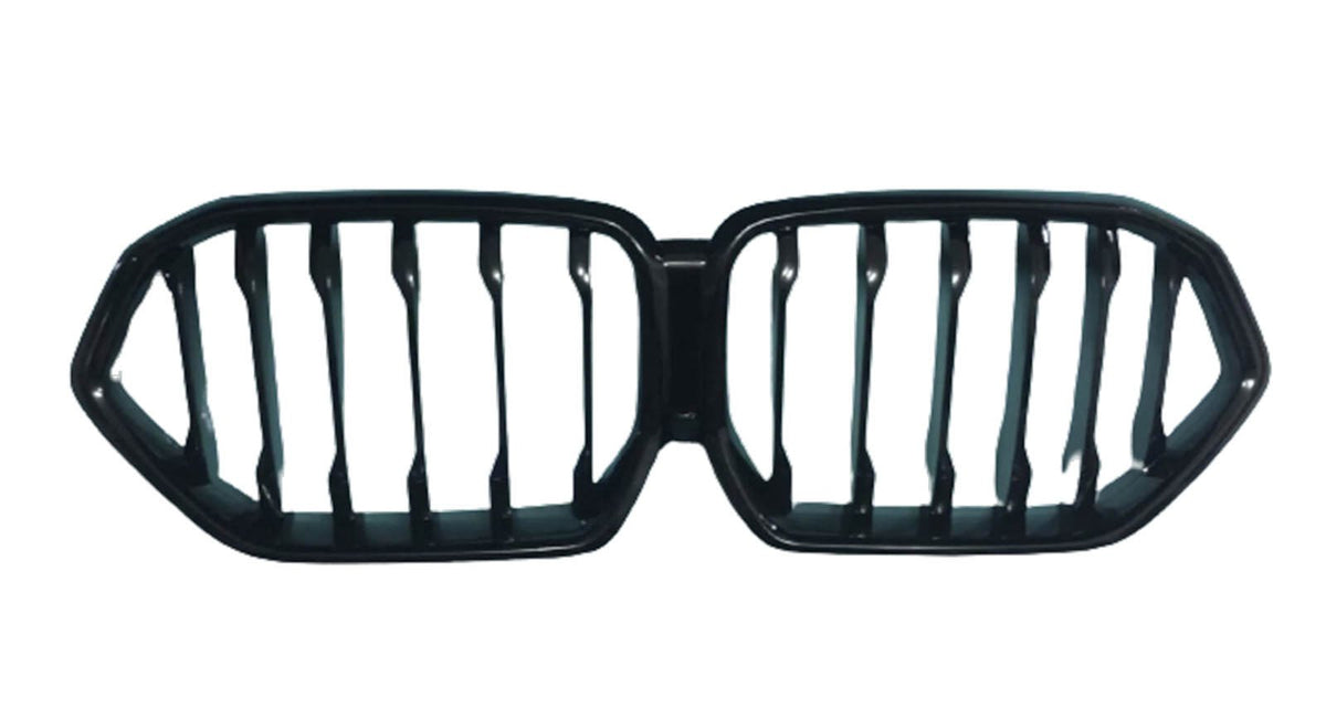 A black automotive grille with a dual-kidney shape, featuring vertical slats. It is isolated on a white background, suggesting it's a part removed for display.