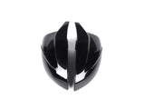 A shiny, black, futuristic helmet with sleek, curved shapes is split down the middle, placed against a plain white background.