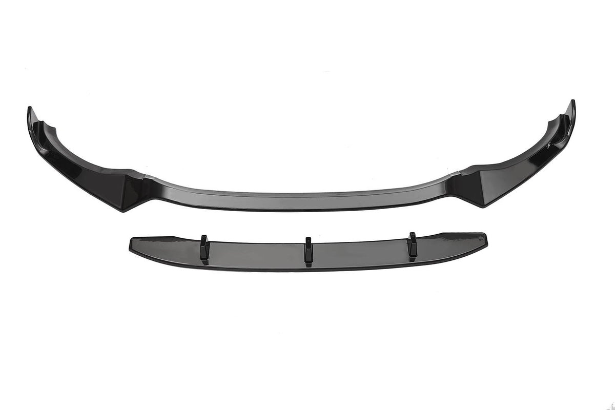 A black car front splitter sits separately on a white background. The upper piece has a curved shape with aerodynamic features, while the lower piece appears flat with mounting points.